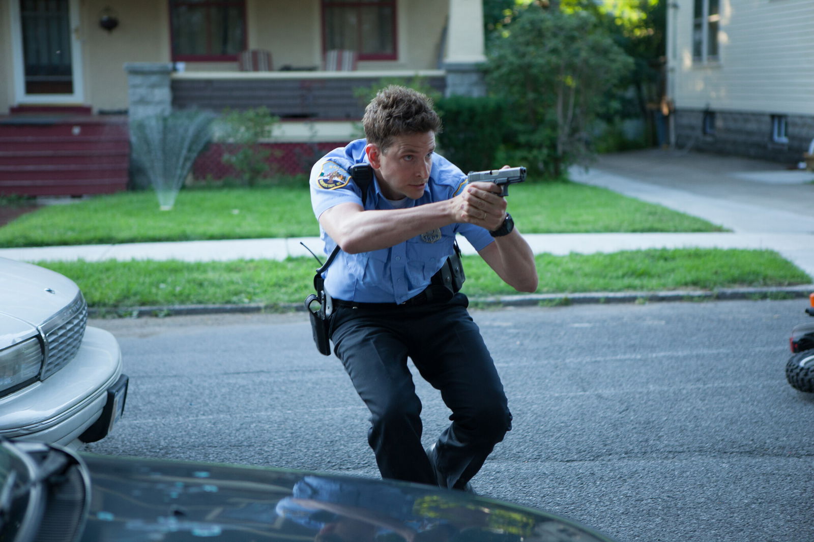 Clicca per vedere l'immagine originale Bradley Cooper poliziotto in azione in una scena di Come un tuono