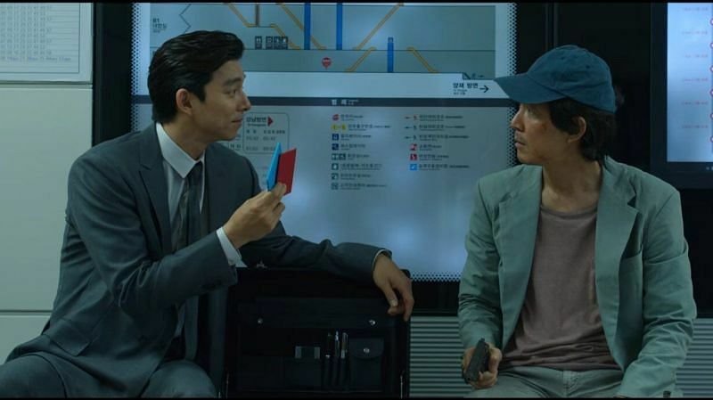 Ο Seong Gi-hun με έναν άντρα με έξυπνο κοστούμι