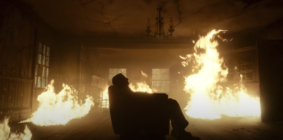 Bradley Cooper seduto in poltrona mentre tutto brucia