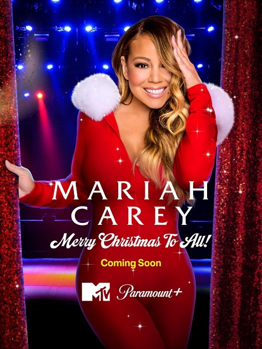 Poster di Mariah Carey: Merry Christmas to All! ! Mariah Carey vestita da Signora Natale sorride con una mano sui capelli